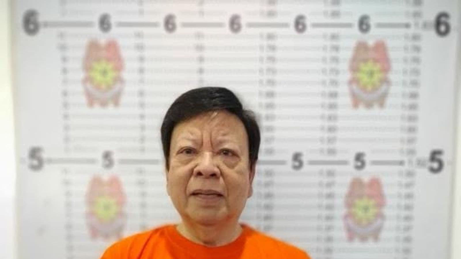 Sen. Rodante Marcoleta in an official CIDG booking photo, holding a placard reading PLUNDER